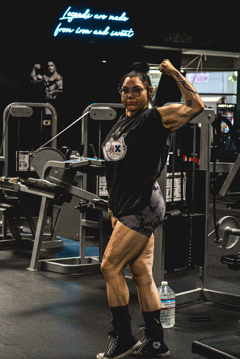 The coach is posing at the gym.